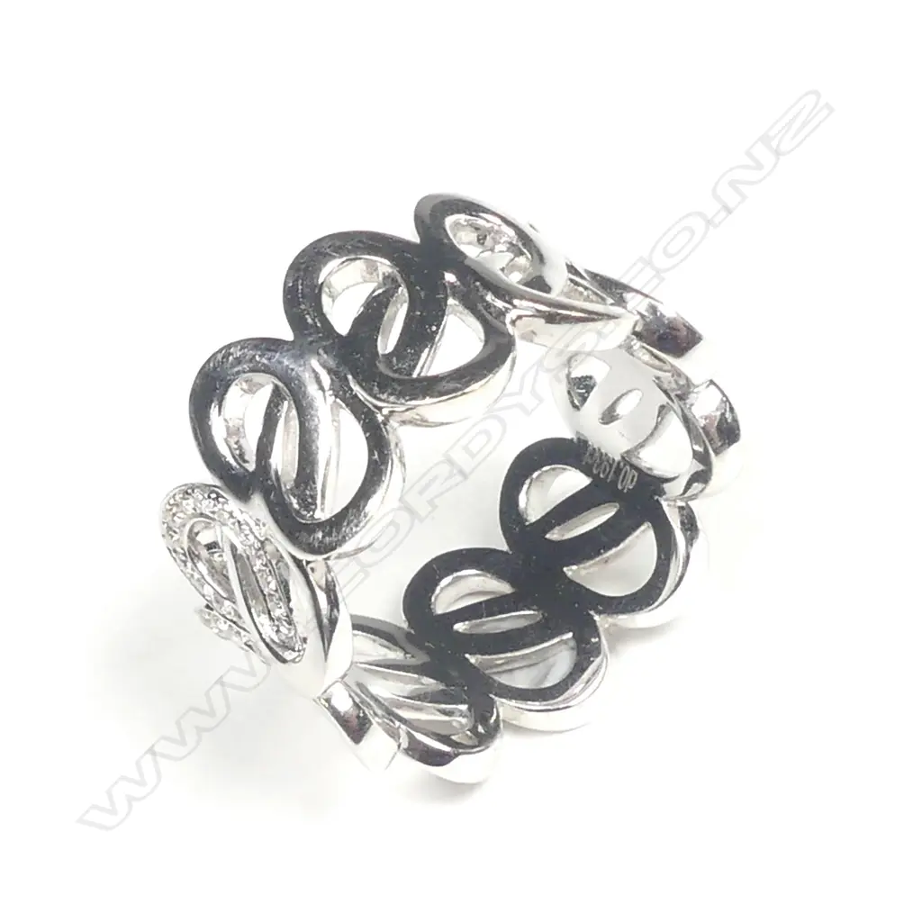 An 18ct. white gold and diamond set lover's knot eternity band Image 1++