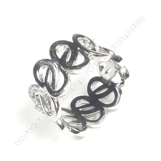 An 18ct. white gold and diamond set lover's knot eternity band