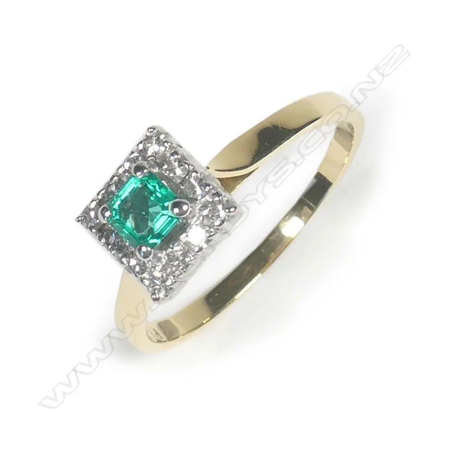 An 18ct gold diamond and emerald ring Image 1++