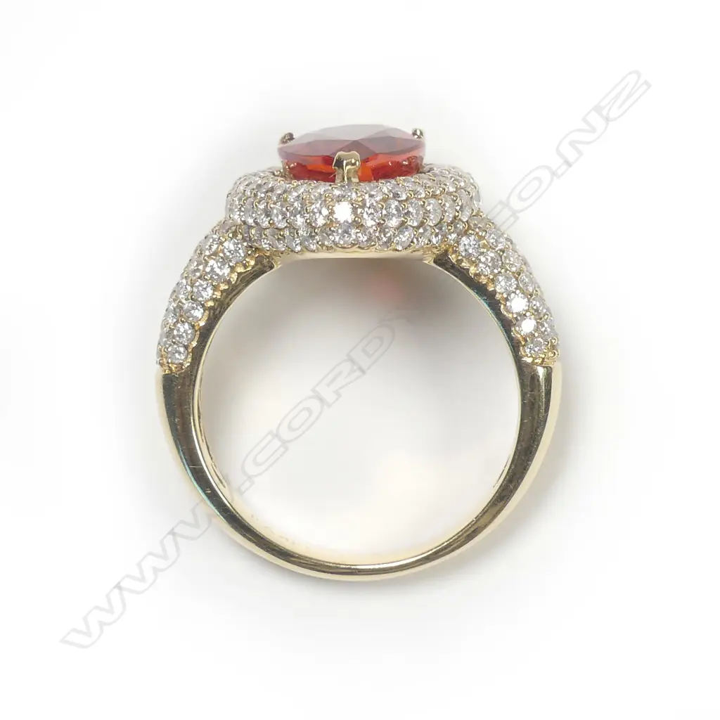A 14ct gold orange sapphire and diamond ring Image 1++