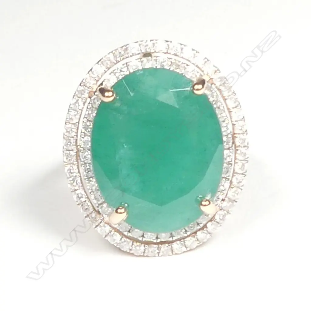 A 14ct rose gold emerald and diamond halo ring Image 1++