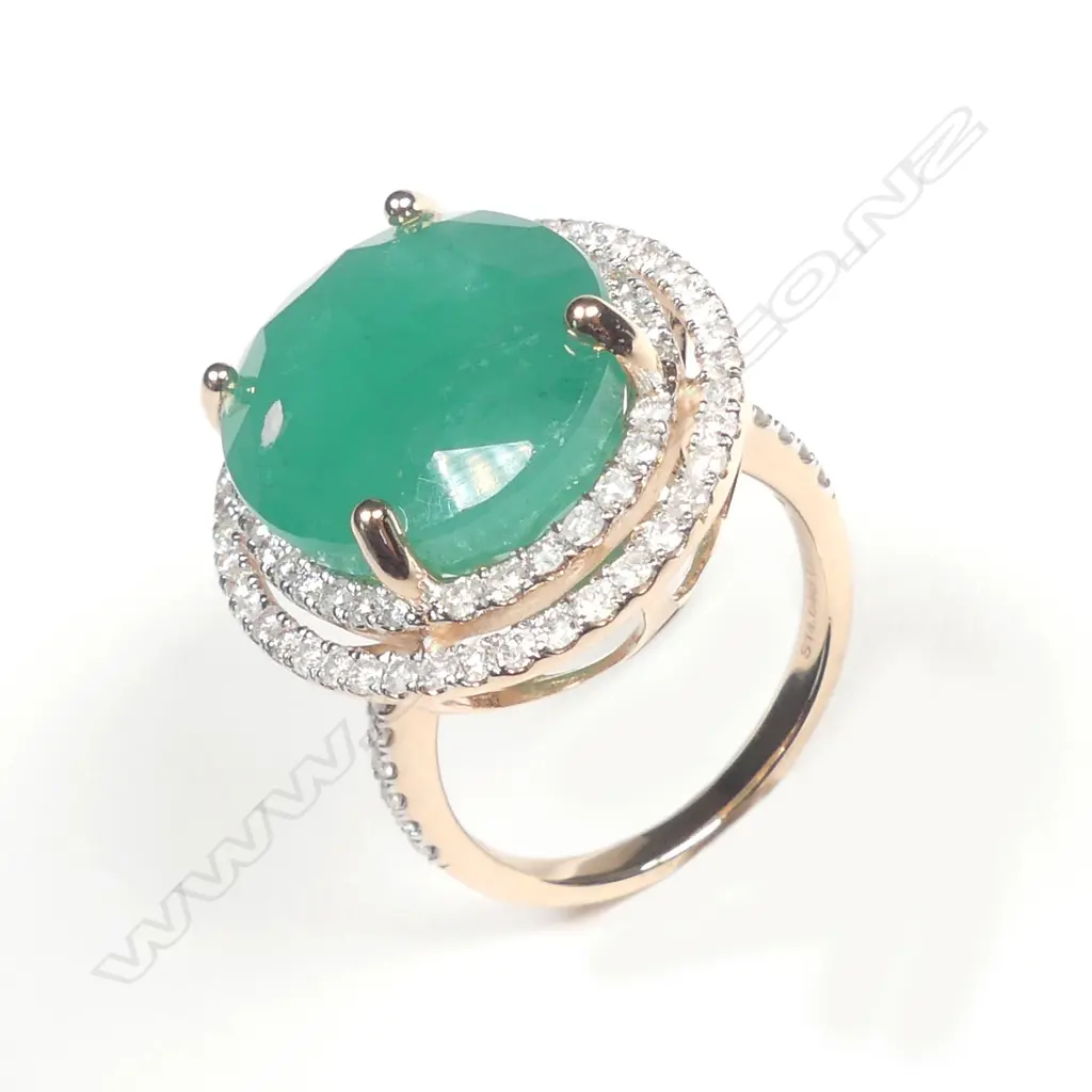 A 14ct rose gold emerald and diamond halo ring Image 1++