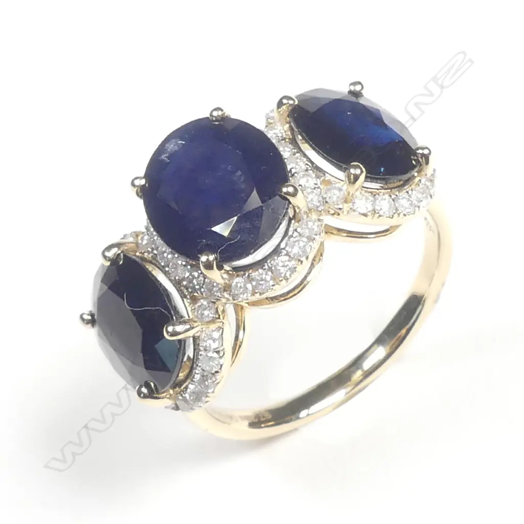 A 14ct gold sapphire and diamond trilogy ring Image 1++