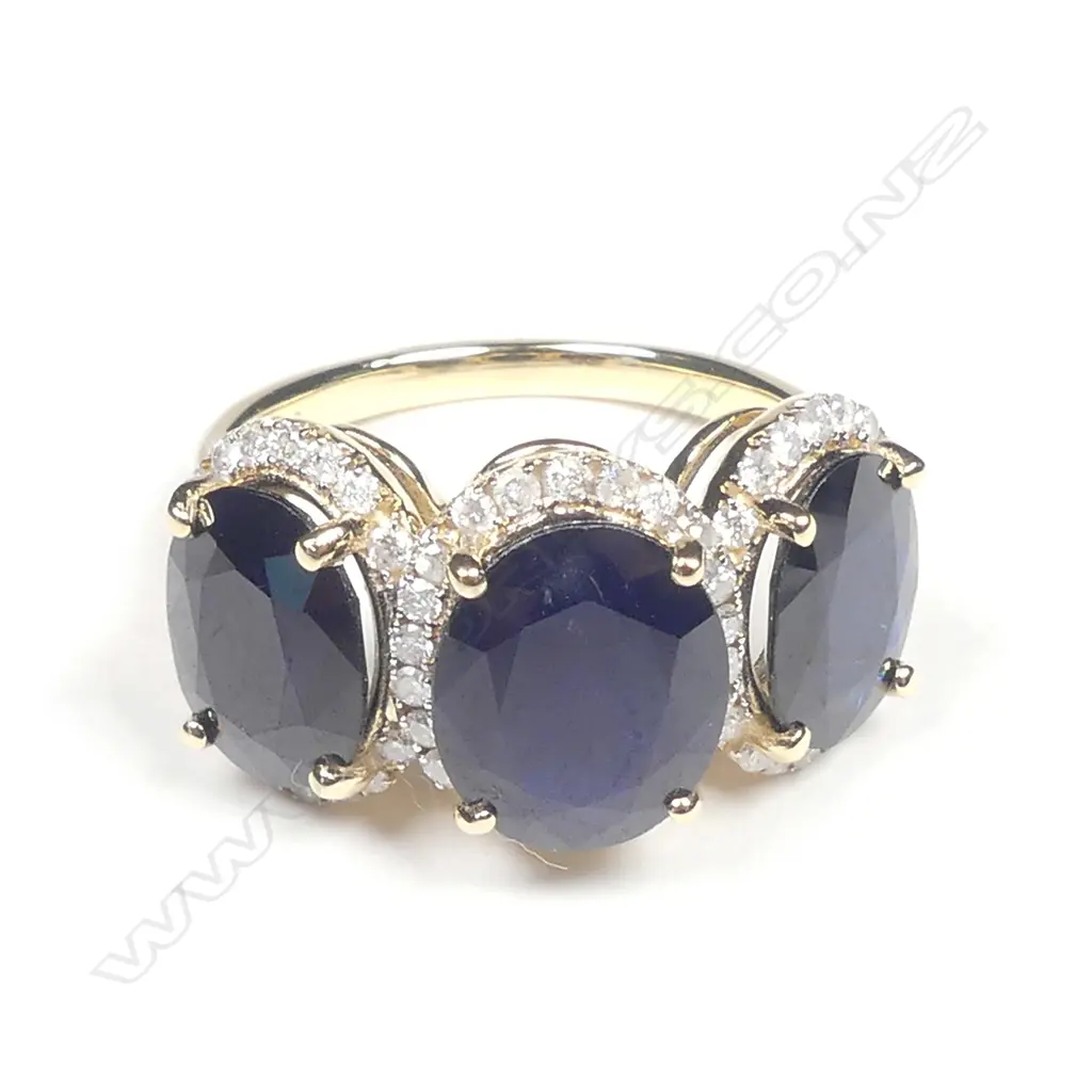 A 14ct gold sapphire and diamond trilogy ring Image 1++