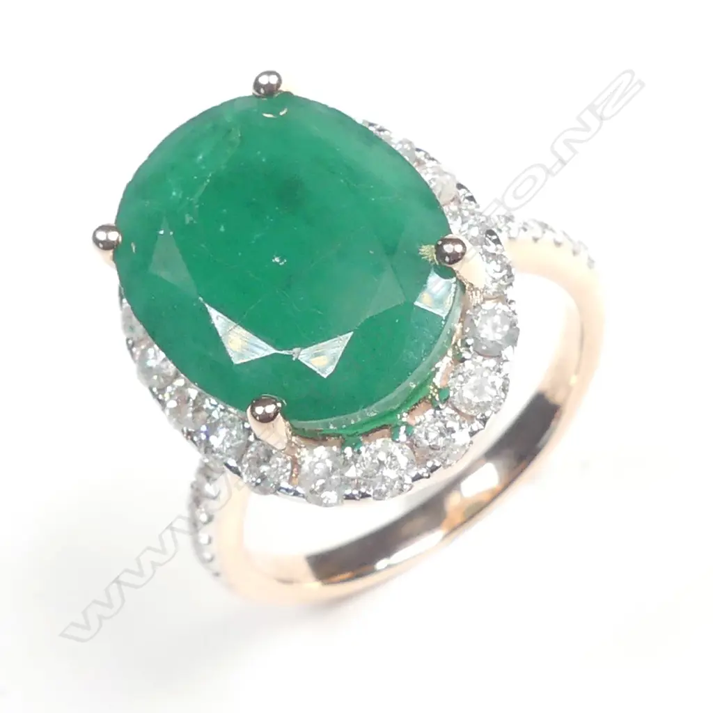A 14ct rose gold emerald and diamond halo ring Image 1++