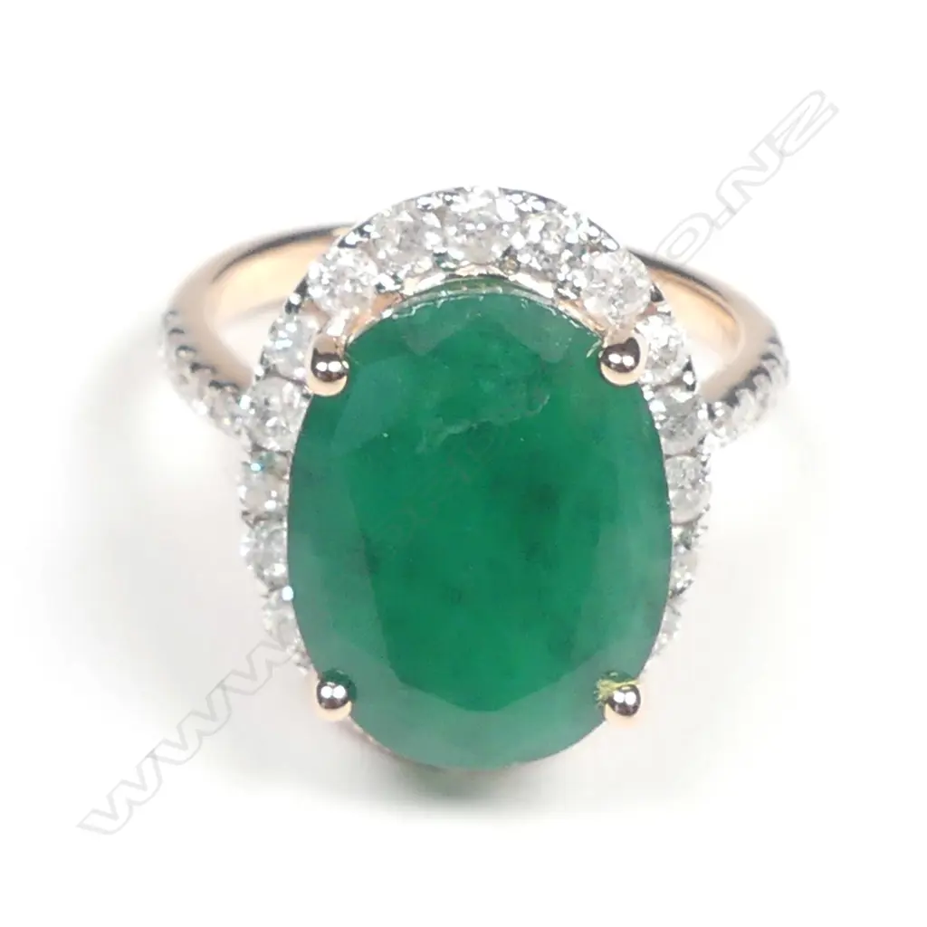 A 14ct rose gold emerald and diamond halo ring Image 1++