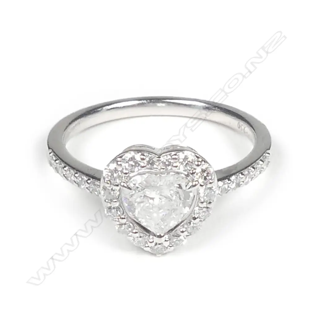 A platinum and diamond halo ring Image 1++