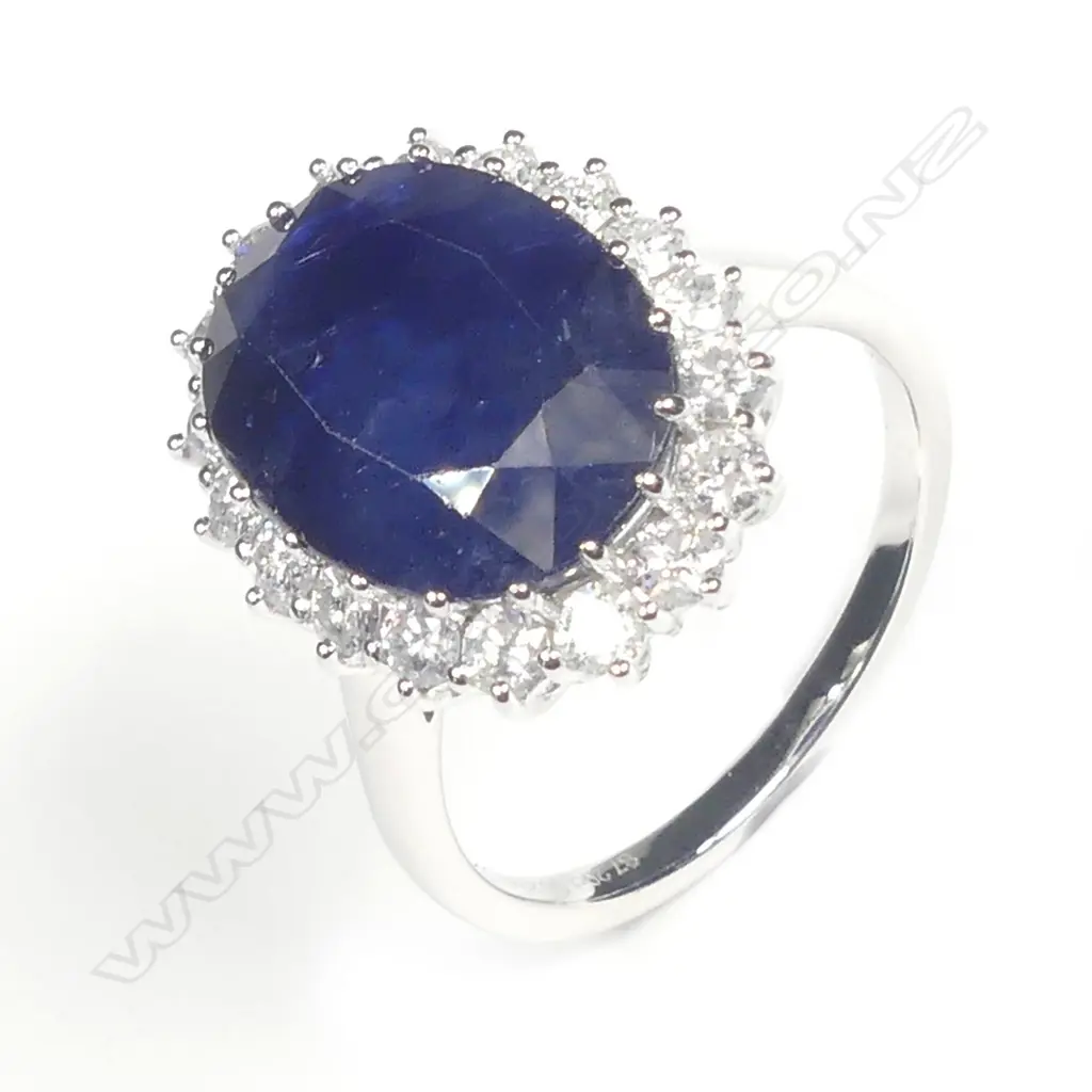 A 14ct white gold sapphire and diamond halo ring Image 1++