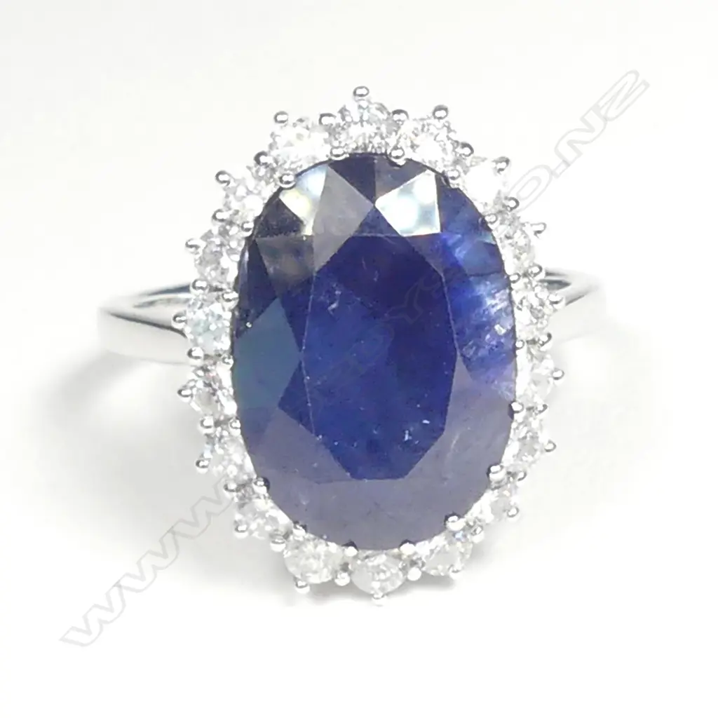 A 14ct white gold sapphire and diamond halo ring Image 1++