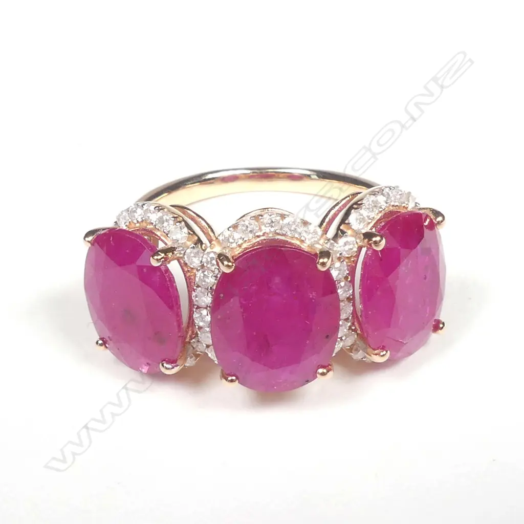 A 14ct rose gold ruby and diamond trilogy ring Image 1++