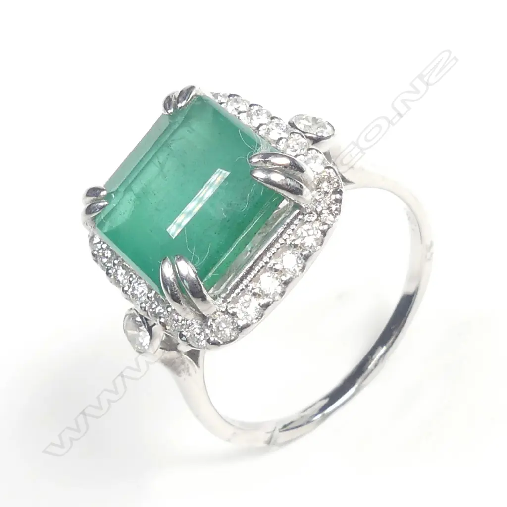 A 14ct white gold emerald and diamond ring Image 1++