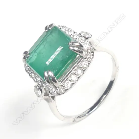 A 14ct white gold emerald and diamond ring