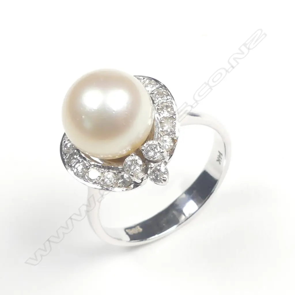 A 14ct. white gold pearl and diamond dress ring Image 1++