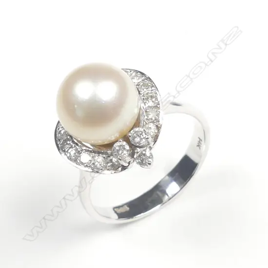 A 14ct. white gold pearl and diamond dress ring