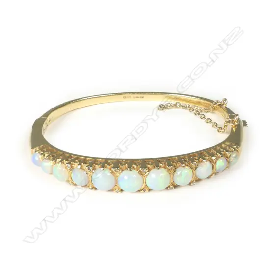 An 18ct gold bracelet set with eleven graduated opals