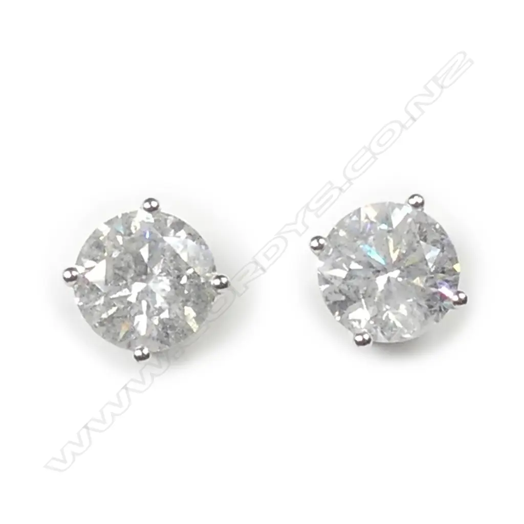 A pair of 18ct white gold and diamond stud earrings Image 1++