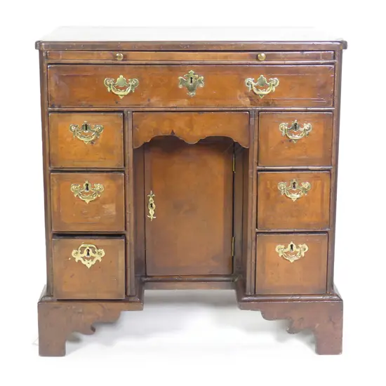 An early Georgian walnut veneer kneehole desk