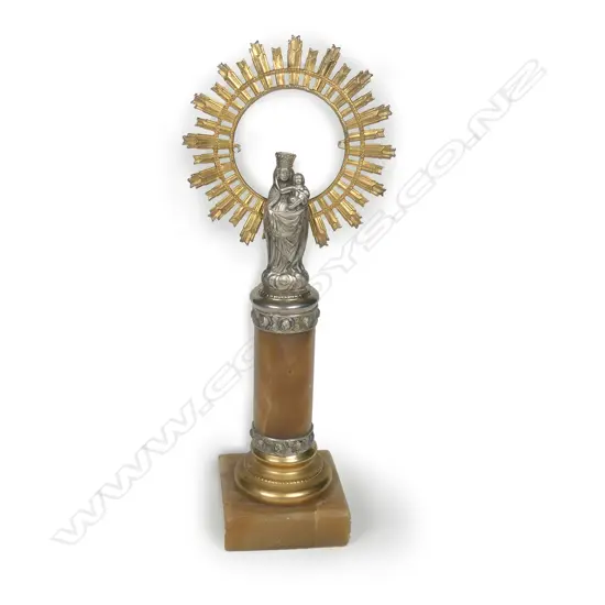 A small silvered metal religious votive figure