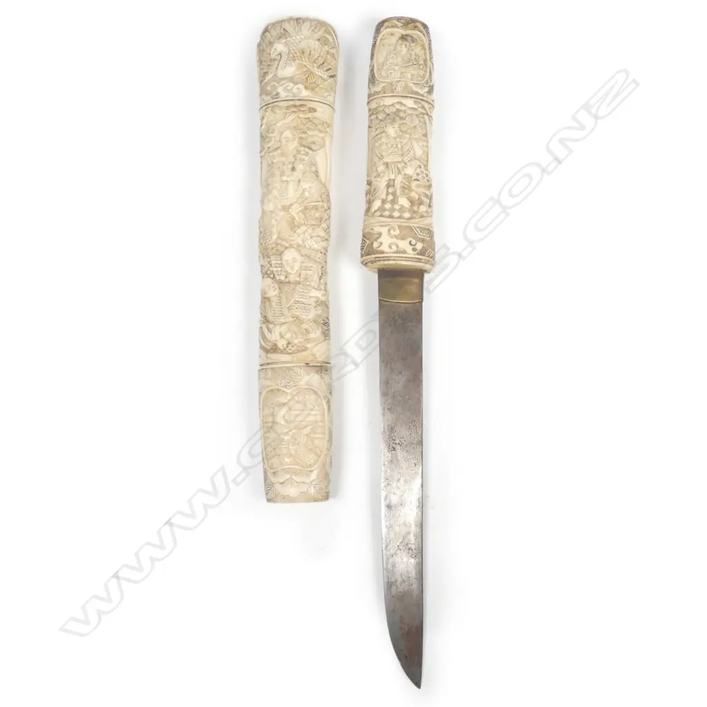 A Japanese short sword with carved bone scabbard and hilt Image 1++