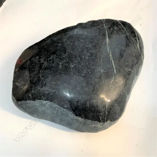 A large pounamu boulder/touch stone with polished top