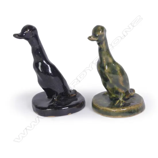 Two Jack Hutchison pottery sculpted ducks; one with green glaze and incised signature to the circular base