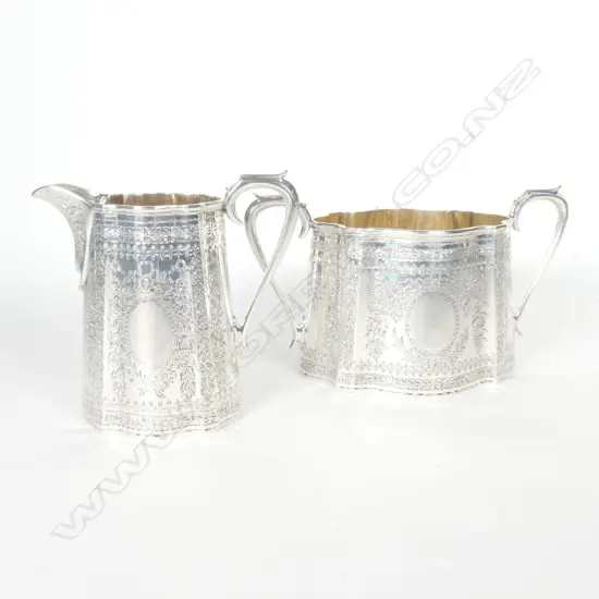 A Victorian silver cream jug and sugar basin