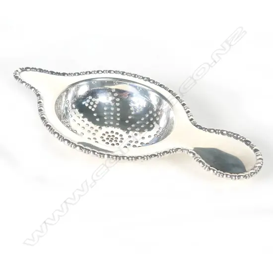 A George V silver tea strainer