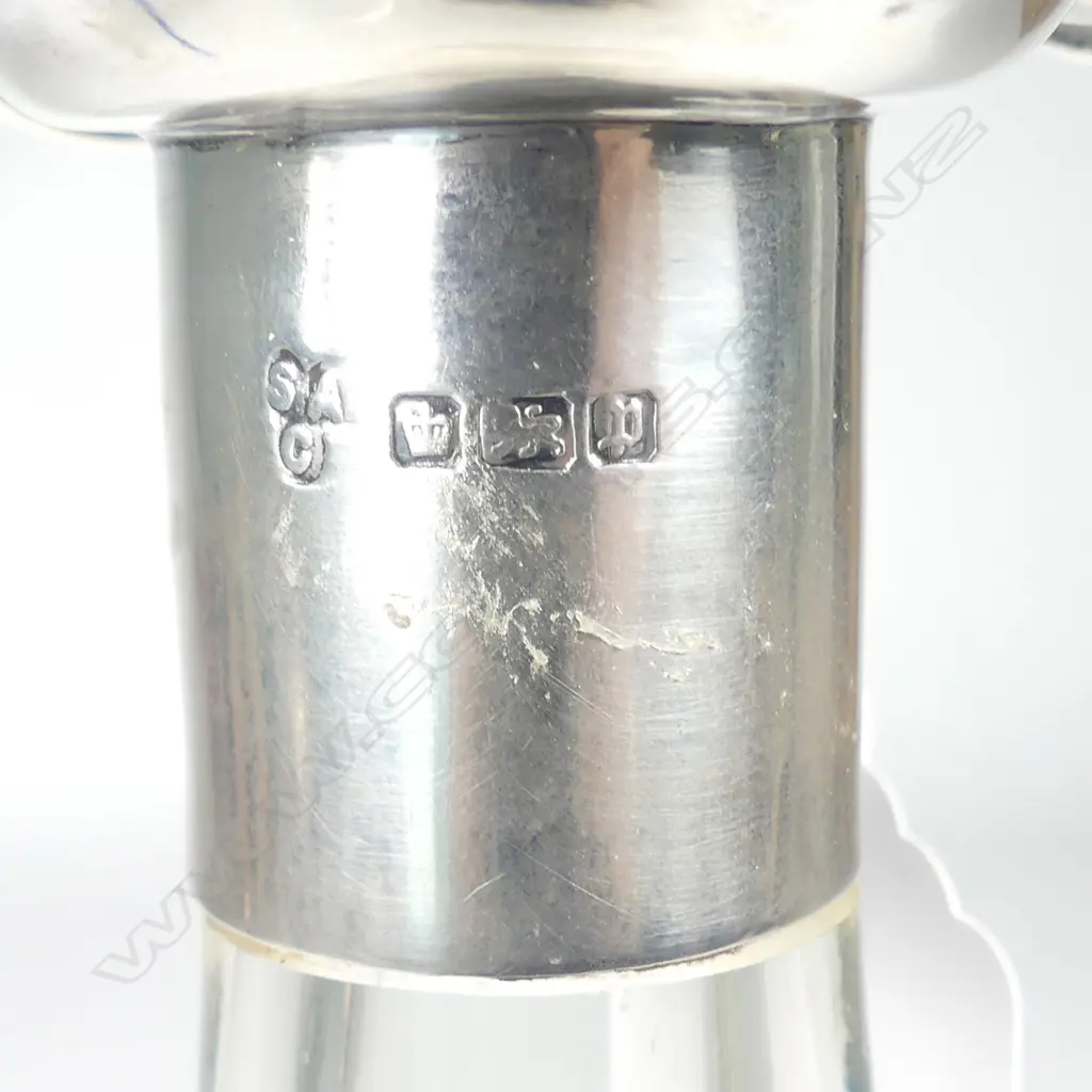 A tall bell shaped crystal decanter with silver collar and mouth Image 1++