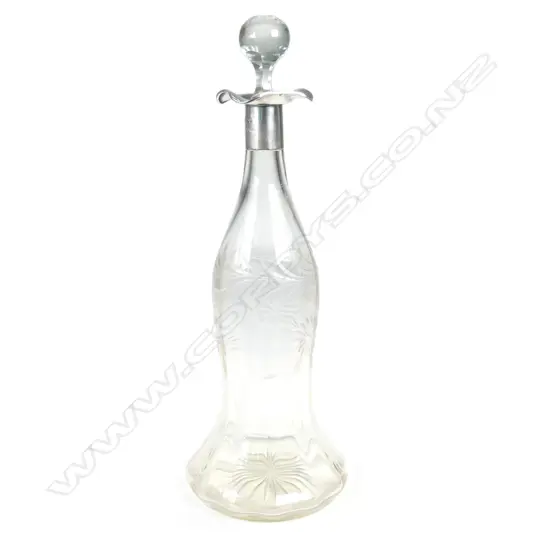 A tall bell shaped crystal decanter with silver collar and mouth