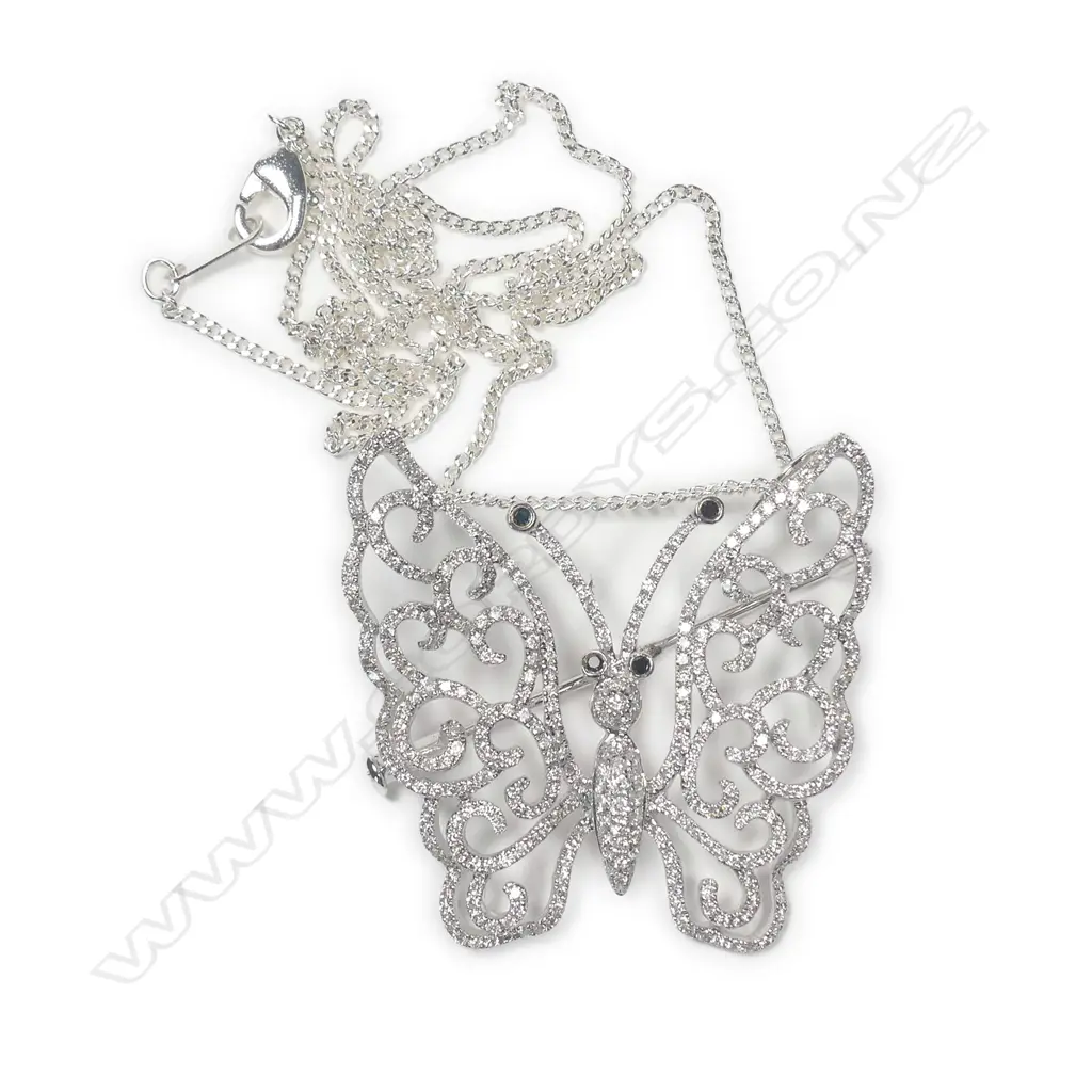 A modern 18ct. white gold and diamond set butterfly pendant/brooch on chain Image 1++