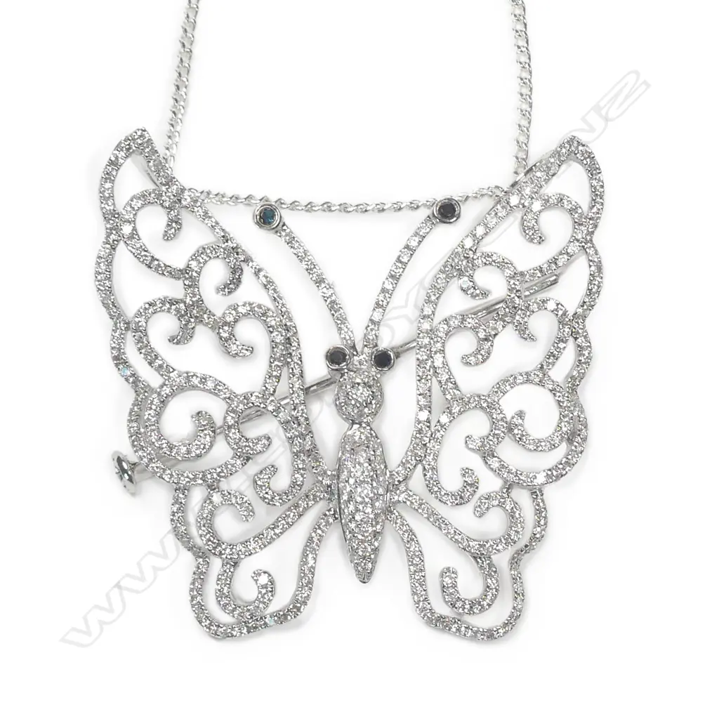 A modern 18ct. white gold and diamond set butterfly pendant/brooch on chain Image 1++