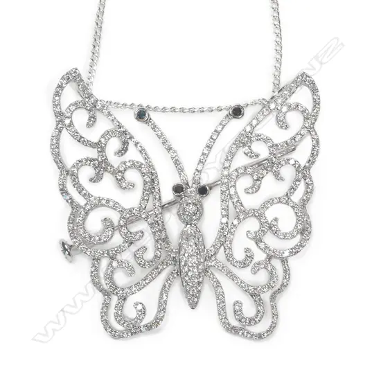 A modern 18ct. white gold and diamond set butterfly pendant/brooch on chain