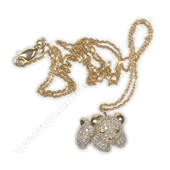 A 9ct. yellow gold and diamond set stylised dog pendant on an 18ct. yellow gold chain