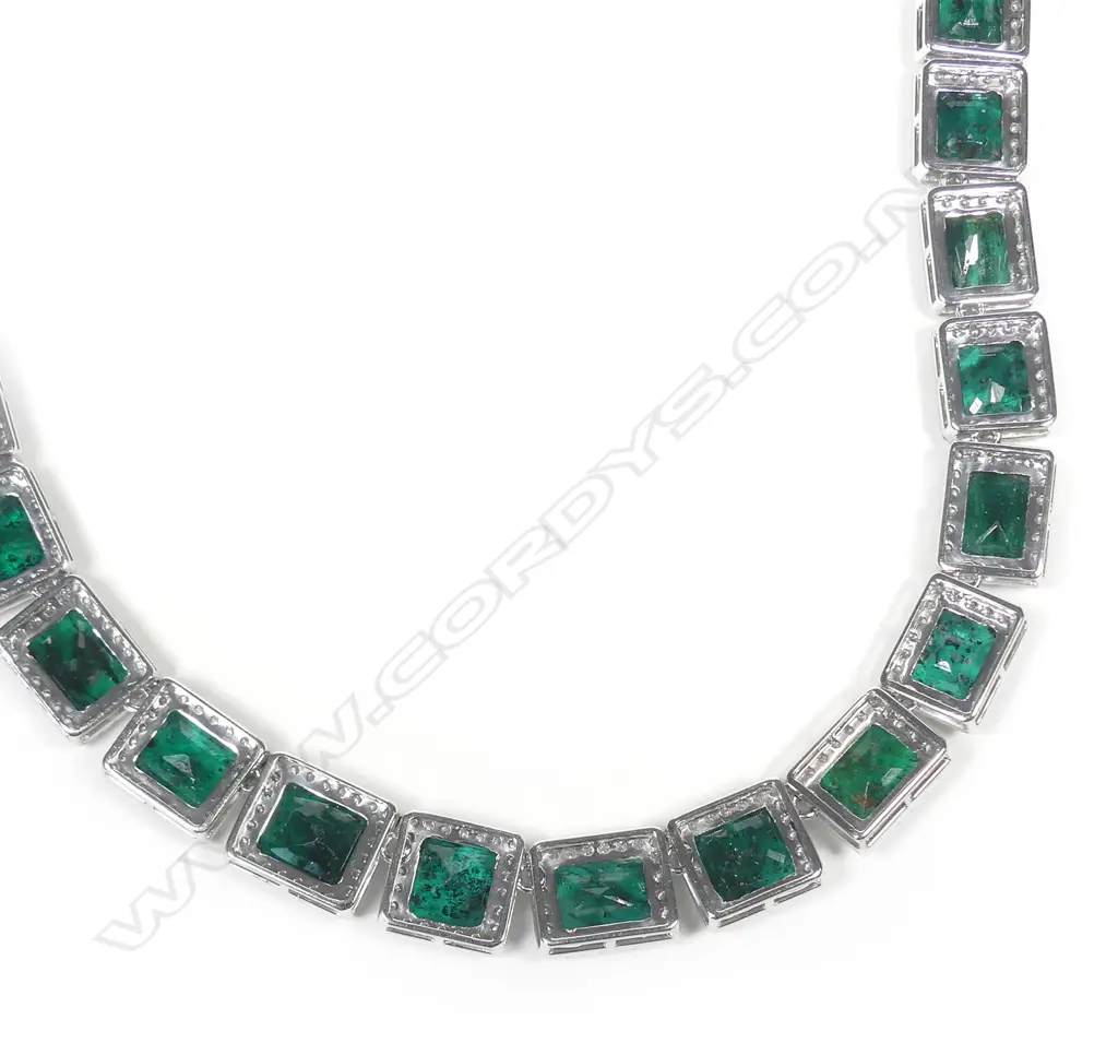 A platinum emerald and diamond halo necklace Image 1++