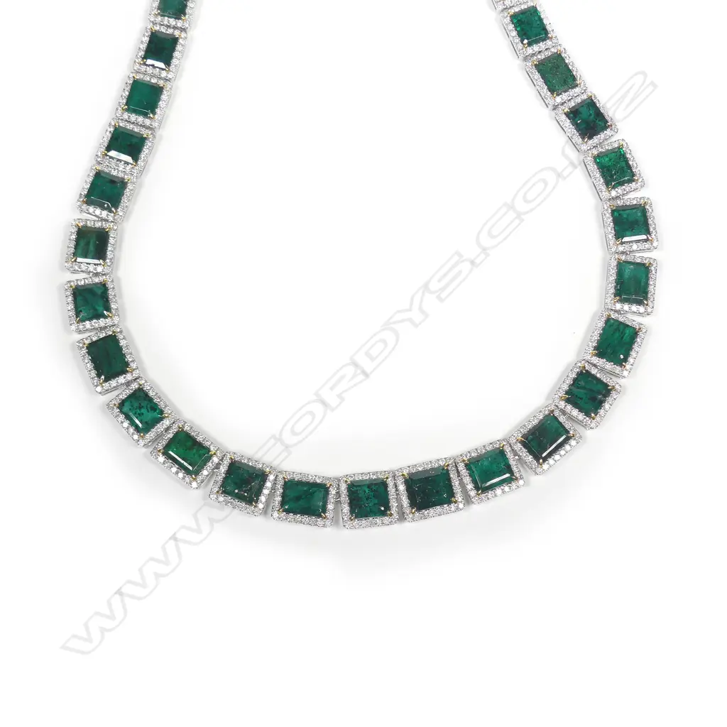 A platinum emerald and diamond halo necklace Image 1++