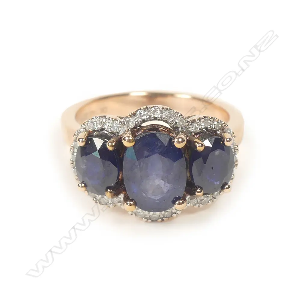 A 14ct rose gold sapphire and diamond trilogy ring Image 1++