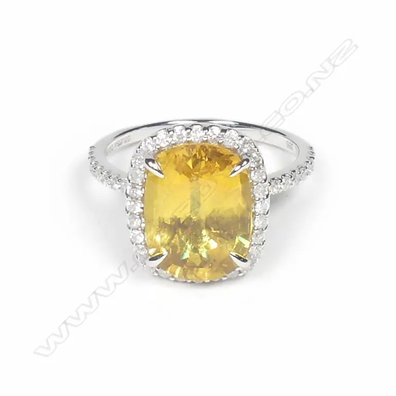 A 14ct white gold sapphire and diamond halo ring Image 1++