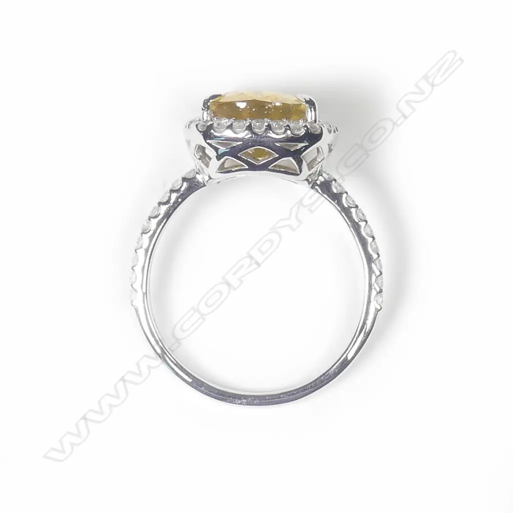 A 14ct white gold sapphire and diamond halo ring Image 1++