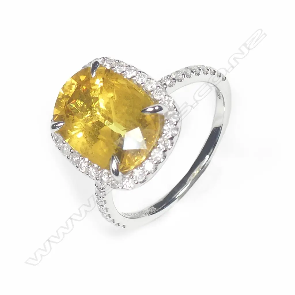 A 14ct white gold sapphire and diamond halo ring Image 1++