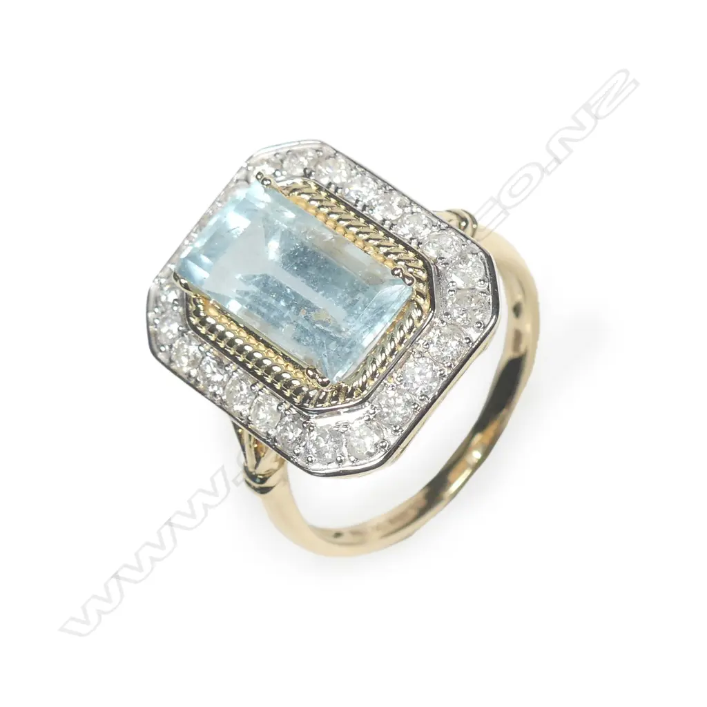 A 14ct gold aquamarine and diamond halo ring Image 1++