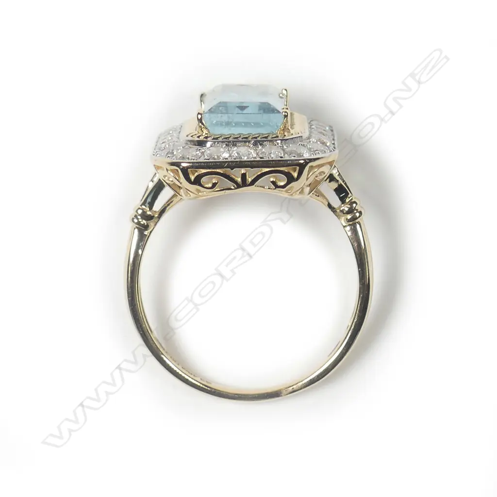 A 14ct gold aquamarine and diamond halo ring Image 1++