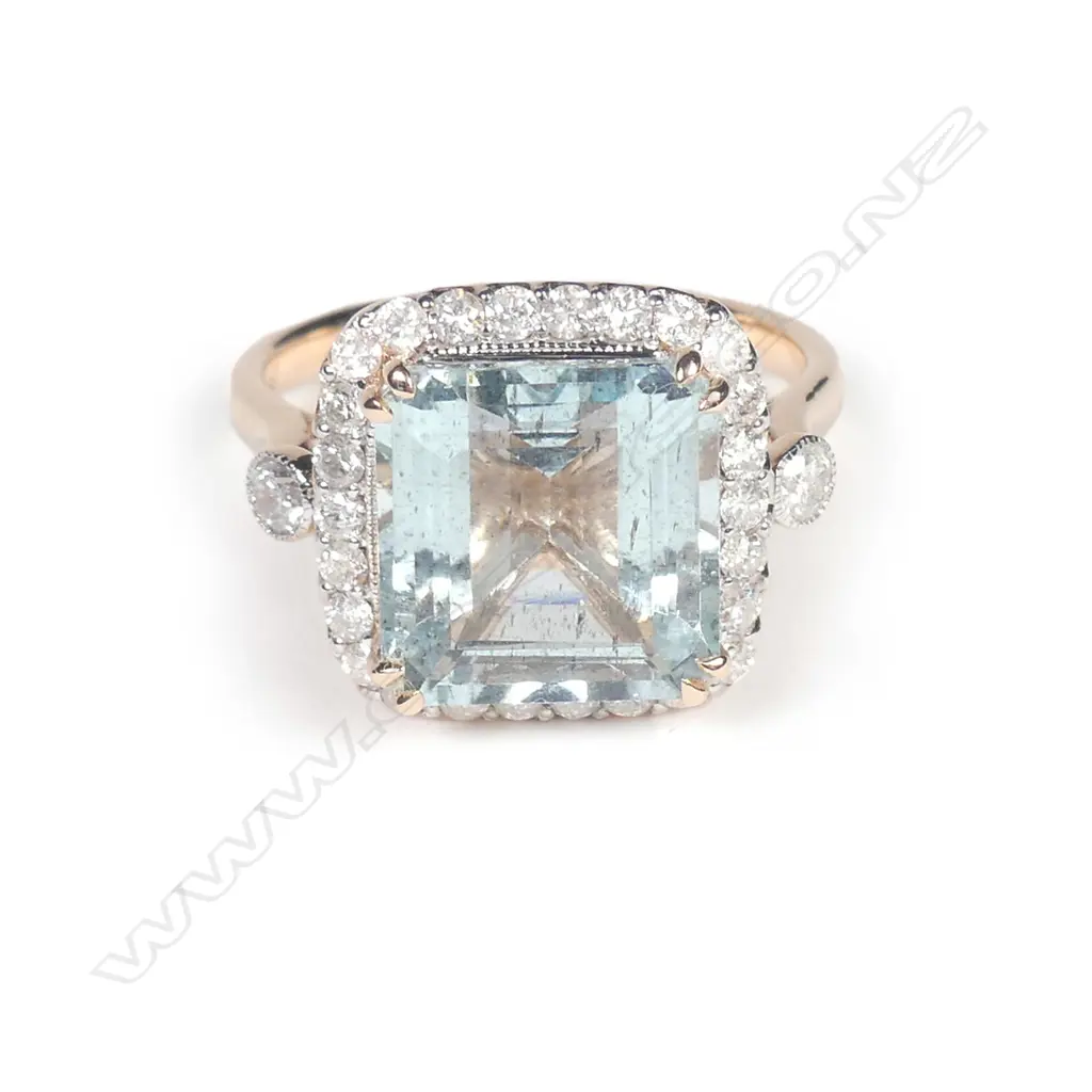 A 14ct rose gold aquamarine and diamond halo ring Image 1++