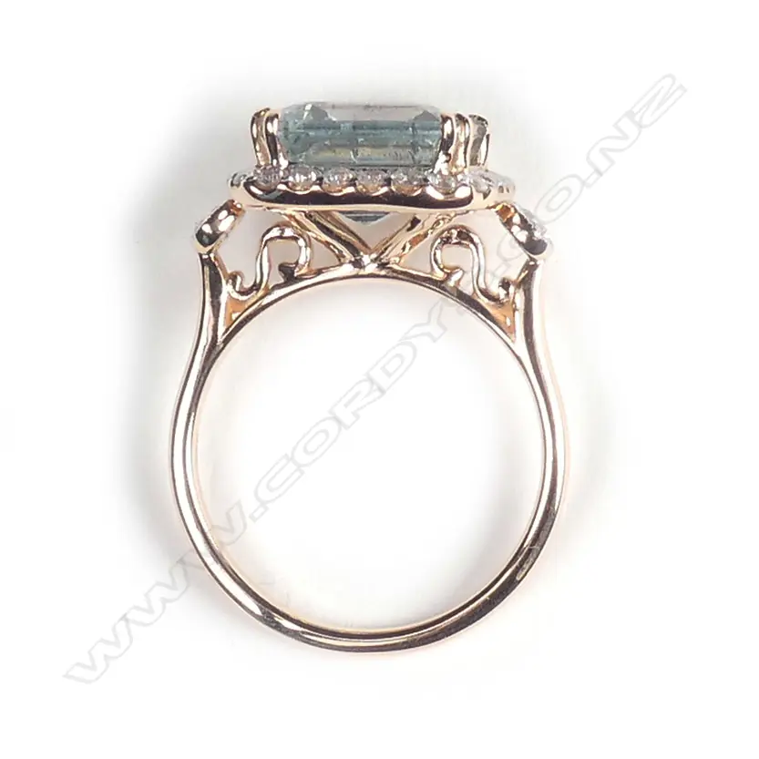 A 14ct rose gold aquamarine and diamond halo ring Image 1++