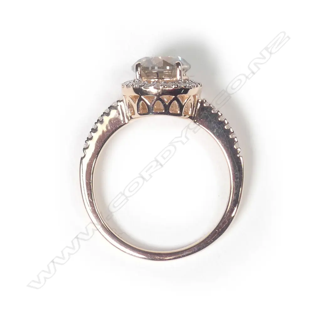 A 14ct rose gold diamond halo ring Image 1++