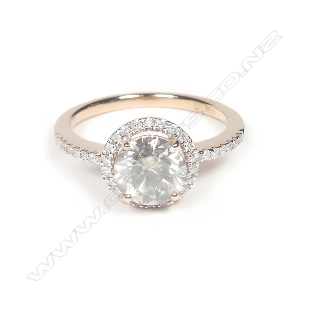 A 14ct rose gold diamond halo ring Image 1++