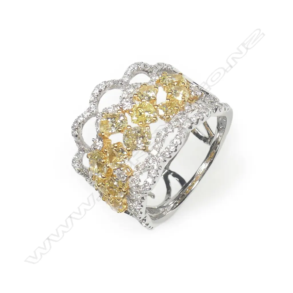An 18ct. white gold fancy yellow and white diamond wide ring Image 1++