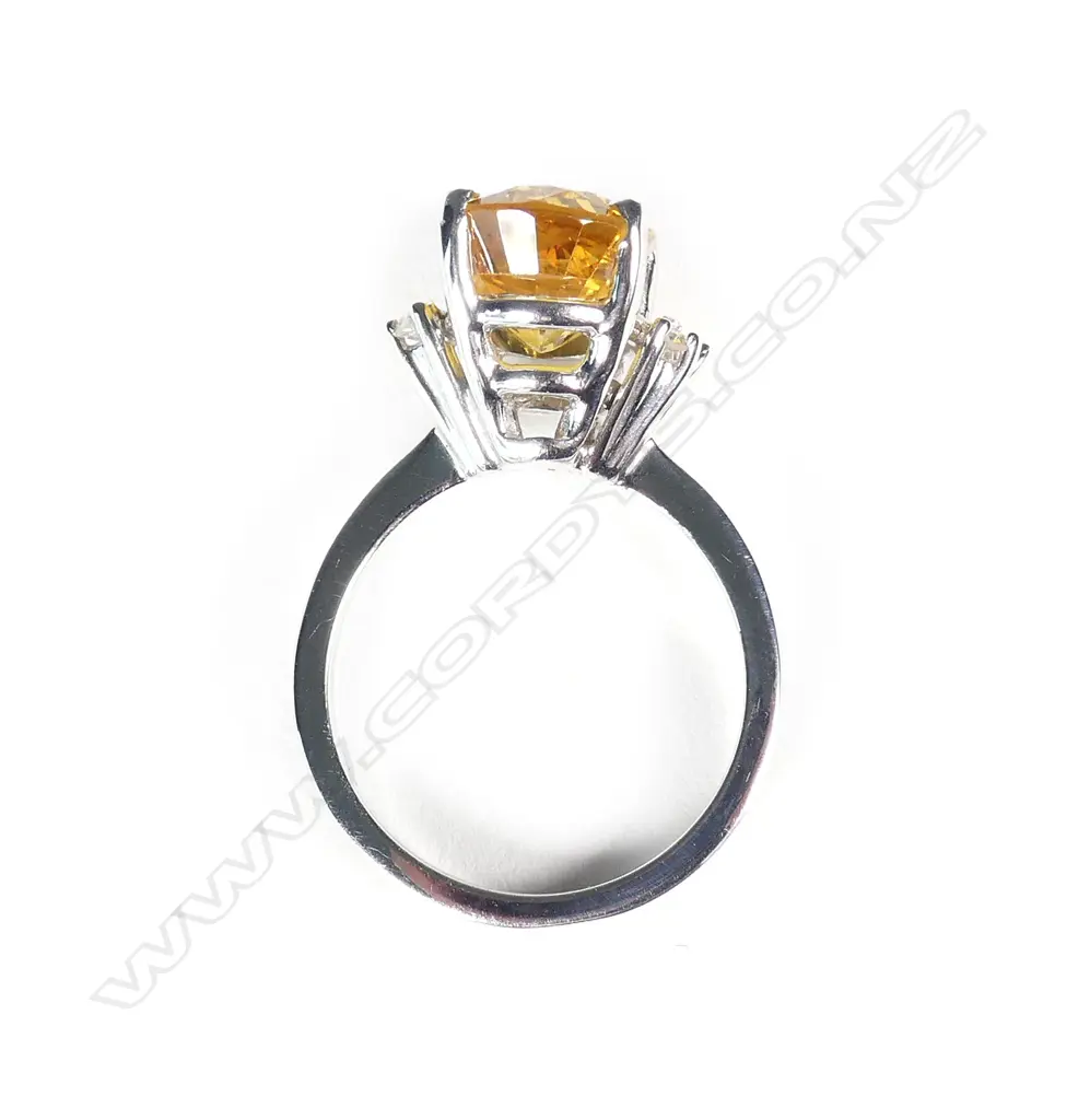 An 18ct white gold and golden sapphire ring Image 1++