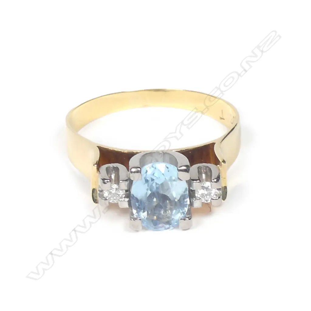 An 18ct gold aquamarine and diamond ring Image 1++