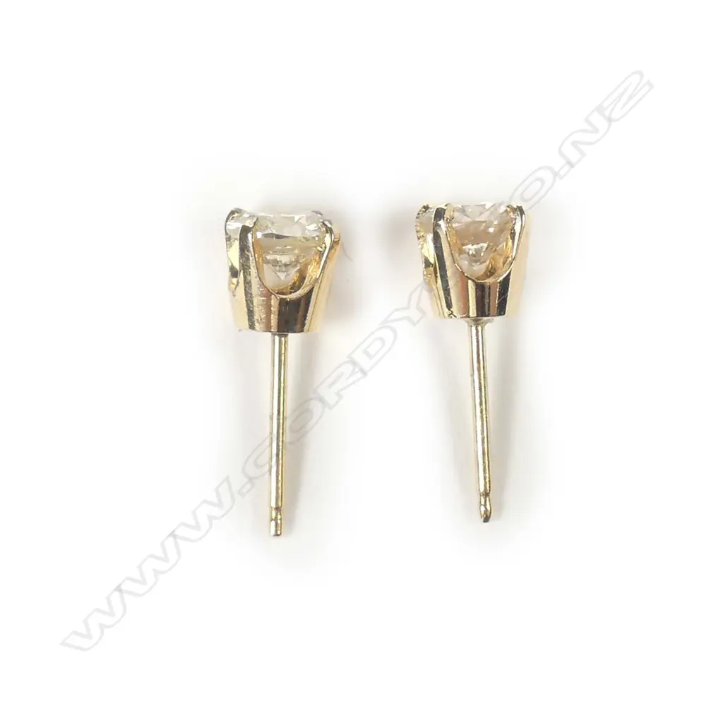 A pair of 9ct yellow gold solitaire diamond earrings Image 1++