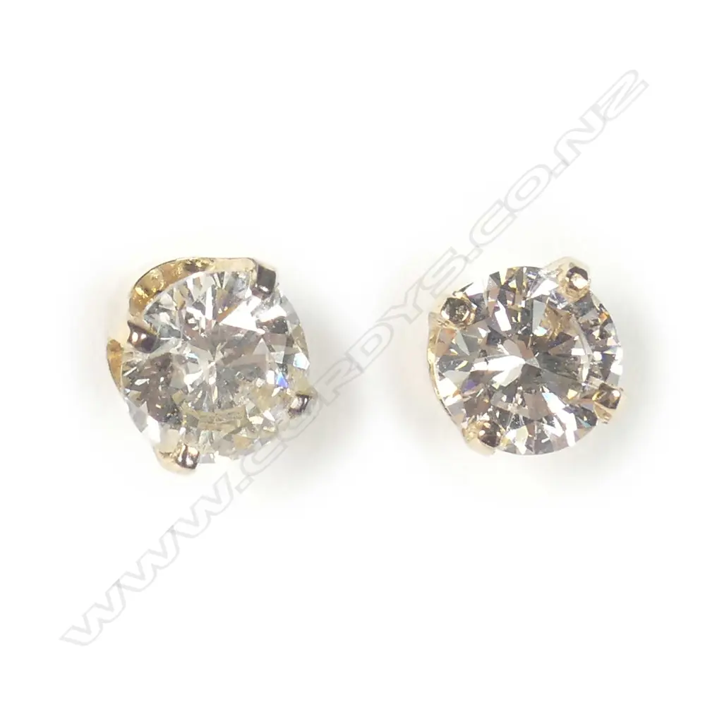 A pair of 9ct yellow gold solitaire diamond earrings Image 1++